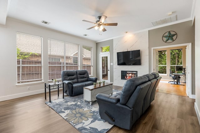 142 Shelby Trce, Murphy, TX 75094 - living area featuring ceiling fan, crown molding, wood finished floors, a premium fireplace, and baseboards
