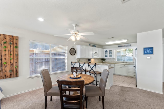 431 Jib Dr, Gun Barrel City, TX 75156 - dining room featuring light colored carpet, a ceiling fan, baseboards, and light tile patterned floors