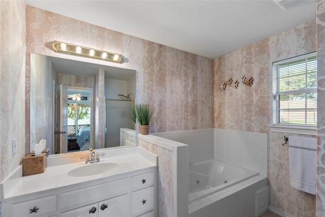 431 Jib Dr, Gun Barrel City, TX 75156 - ensuite bathroom with wallpapered walls, a tub with jets, vanity, and a textured ceiling