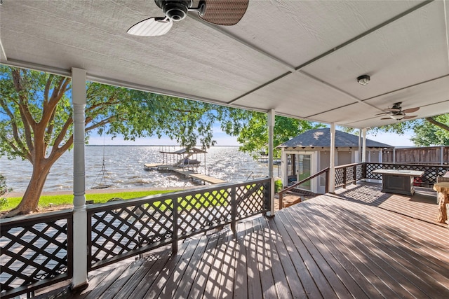 431 Jib Dr, Gun Barrel City, TX 75156 - wooden deck featuring a water view, ceiling fan, and an outbuilding