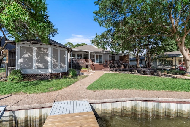 431 Jib Dr, Gun Barrel City, TX 75156 - rear view of property featuring a sunroom, a lawn, and a deck