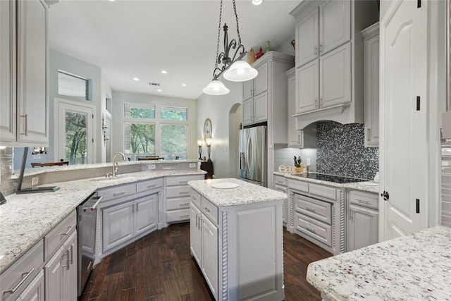 1447 Cimarron Trl, Hurst, TX 76053 - kitchen with stainless steel appliances, gray cabinets, decorative backsplash, recessed lighting, and dark wood finished floors