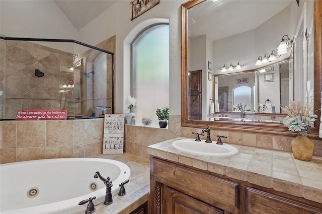 1447 Cimarron Trl, Hurst, TX 76053 - full bathroom with a jetted tub, a shower stall, vanity, healthy amount of natural light, and vaulted ceiling
