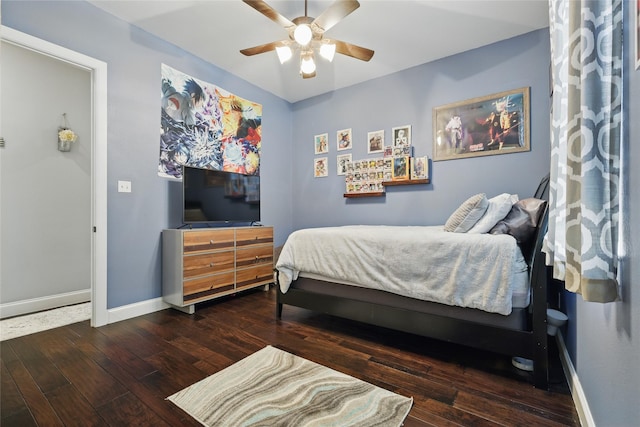 1447 Cimarron Trl, Hurst, TX 76053 - bedroom featuring hardwood / wood-style floors, baseboards, and a ceiling fan