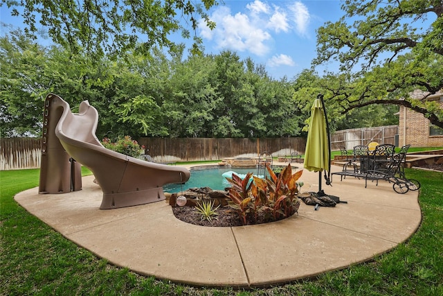 1447 Cimarron Trl, Hurst, TX 76053 - view of swimming pool with a water slide, a fenced backyard, and a patio area