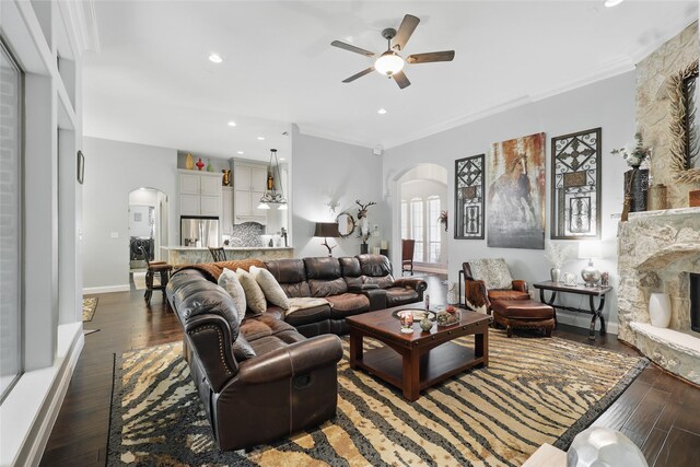 1447 Cimarron Trl, Hurst, TX 76053 - living room featuring arched walkways, a ceiling fan, wood-type flooring, crown molding, and recessed lighting