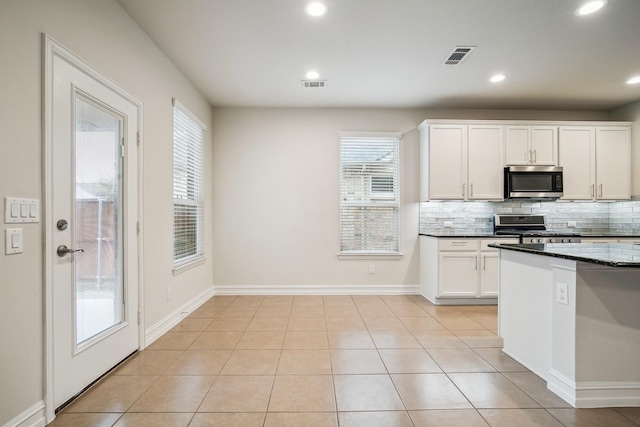2341 Leeward Pl, Little Elm, TX 75068 - kitchen with appliances with stainless steel finishes, backsplash, white cabinetry, recessed lighting, and baseboards