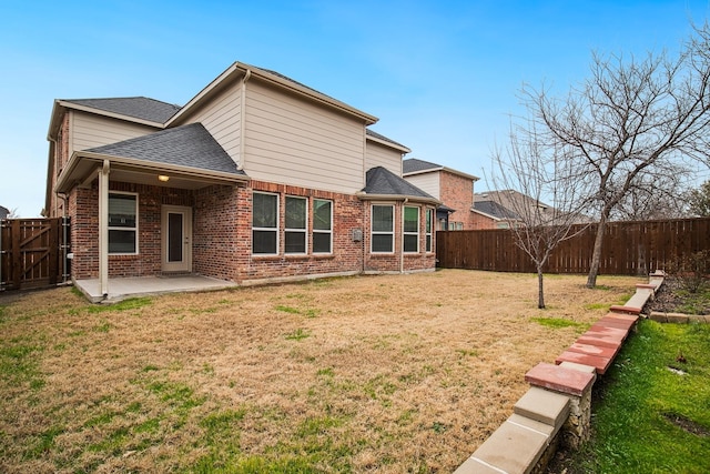 2341 Leeward Pl, Little Elm, TX 75068 - rear view of property featuring a patio, a shingled roof, and brick siding