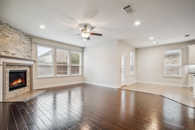 2341 Leeward Pl, Little Elm, TX 75068 - unfurnished living room with a ceiling fan, a stone fireplace, wood finished floors, recessed lighting, and baseboards
