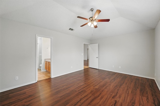 1412 Mockingbird Ln, Desoto, TX 75115 - unfurnished bedroom featuring wood finished floors, baseboards, connected bathroom, lofted ceiling, and a ceiling fan