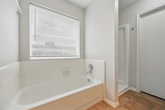 1412 Mockingbird Ln, Desoto, TX 75115 - full bath featuring tile patterned flooring, a garden tub, and healthy amount of natural light