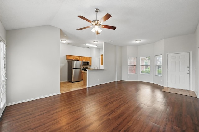 1412 Mockingbird Ln, Desoto, TX 75115 - unfurnished living room with a ceiling fan, wood finished floors, baseboards, lofted ceiling, and a sink