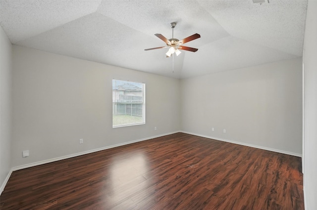1412 Mockingbird Ln, Desoto, TX 75115 - unfurnished room featuring a ceiling fan, dark wood-type flooring, vaulted ceiling, baseboards, and a textured ceiling