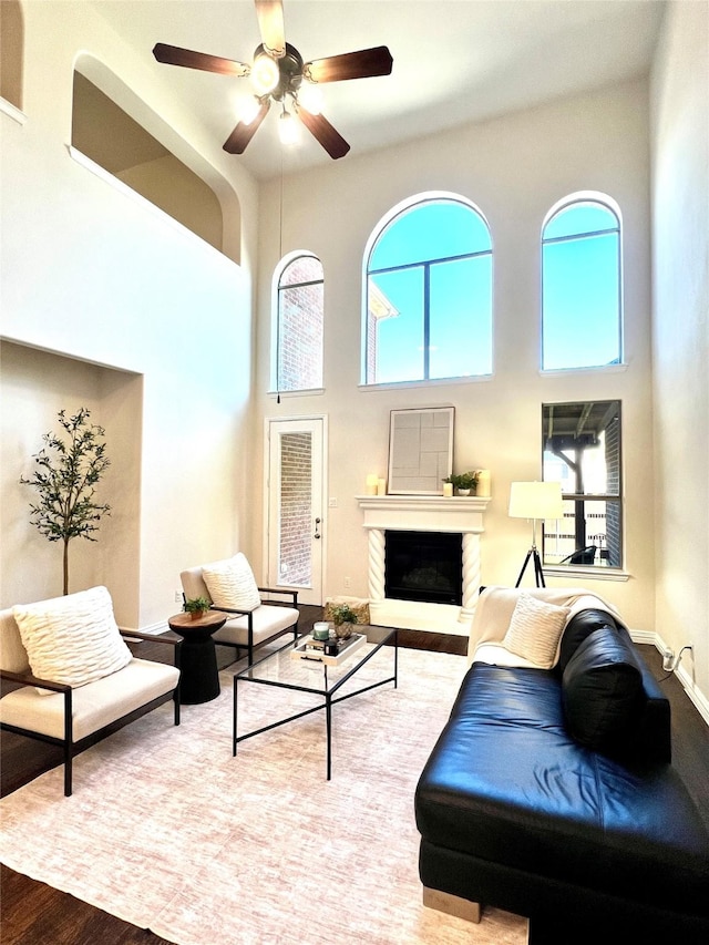 4561 Firewheel Dr, Plano, TX 75024 - living area featuring a high ceiling, wood finished floors, a ceiling fan, and a fireplace