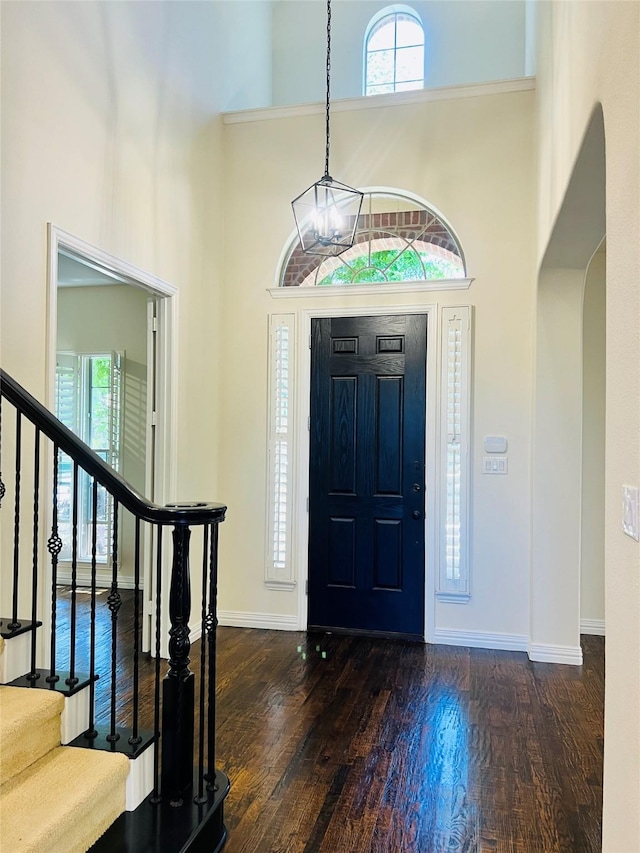 4561 Firewheel Dr, Plano, TX 75024 - entryway with arched walkways, plenty of natural light, stairway, a high ceiling, and wood finished floors