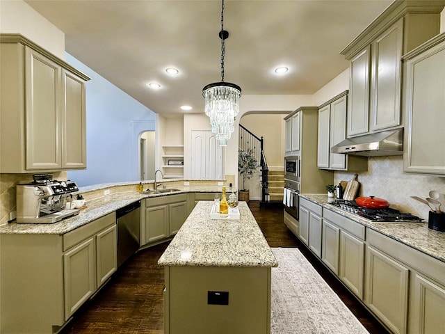 4561 Firewheel Dr, Plano, TX 75024 - kitchen with appliances with stainless steel finishes, a sink, under cabinet range hood, a peninsula, and a center island