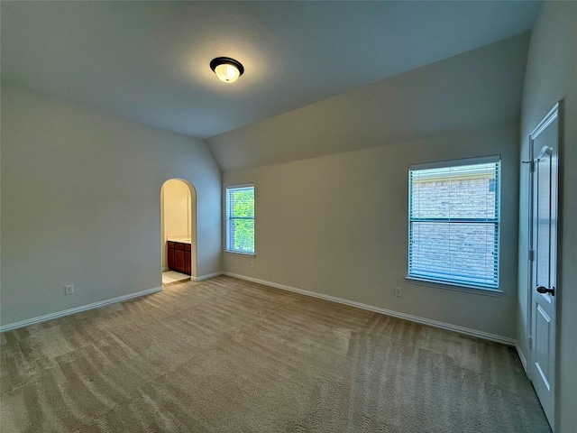 4561 Firewheel Dr, Plano, TX 75024 - carpeted empty room featuring lofted ceiling, baseboards, and arched walkways