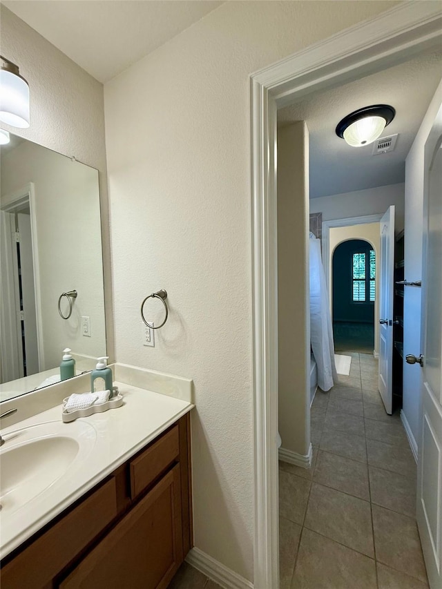 4561 Firewheel Dr, Plano, TX 75024 - bathroom with vanity, tile patterned floors, a textured wall, and baseboards