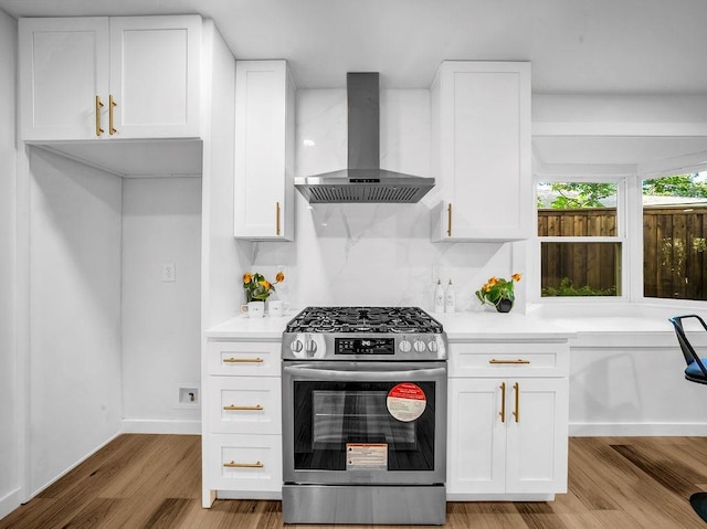 2371 Chart Dr, Dallas, TX 75228 - kitchen with stainless steel range with gas cooktop, wall chimney exhaust hood, and white cabinetry