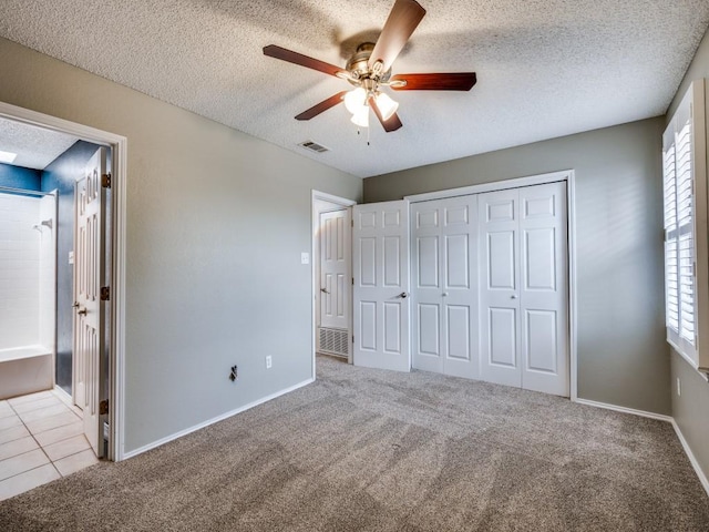 46 Morrow Dr, Bedford, TX 76021 - unfurnished bedroom with multiple windows, a textured ceiling, carpet floors, a closet, and ceiling fan