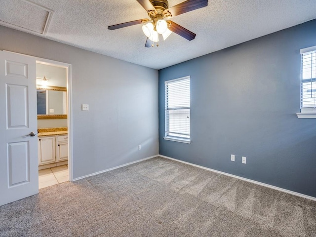 46 Morrow Dr, Bedford, TX 76021 - spare room featuring light colored carpet, plenty of natural light, ceiling fan, a textured ceiling, and baseboards