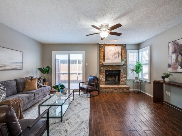 46 Morrow Dr, Bedford, TX 76021 - living area featuring ceiling fan, a brick fireplace, plenty of natural light, wood finished floors, and a textured ceiling