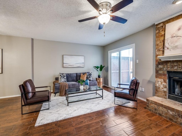 46 Morrow Dr, Bedford, TX 76021 - living room with a fireplace, a textured ceiling, wood finished floors, ceiling fan, and baseboards