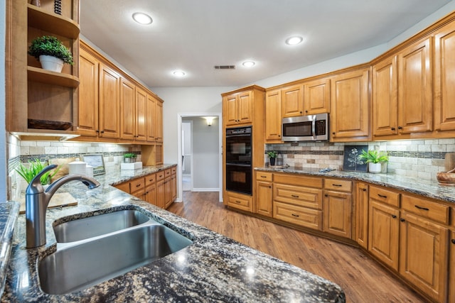 7968 Fm 121, Van Alstyne, TX 75495 - kitchen featuring a sink, black appliances, open shelves, backsplash, and dark stone counters