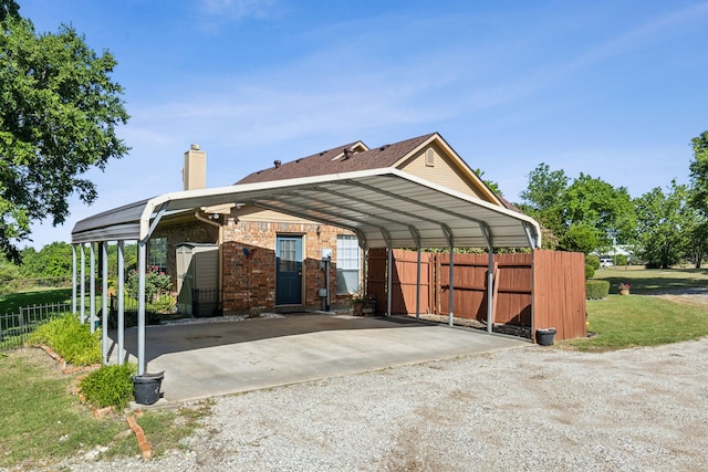 7968 Fm 121, Van Alstyne, TX 75495 - view of side of home with a detached carport, driveway, a chimney, and brick siding