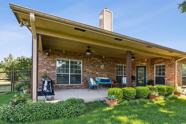 7968 Fm 121, Van Alstyne, TX 75495 - back of property with ceiling fan, a patio area, brick siding, and a chimney