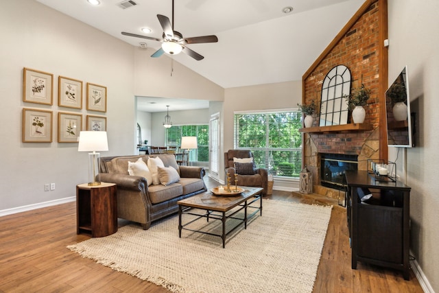 7968 Fm 121, Van Alstyne, TX 75495 - living area featuring ceiling fan, a brick fireplace, wood finished floors, baseboards, and high vaulted ceiling