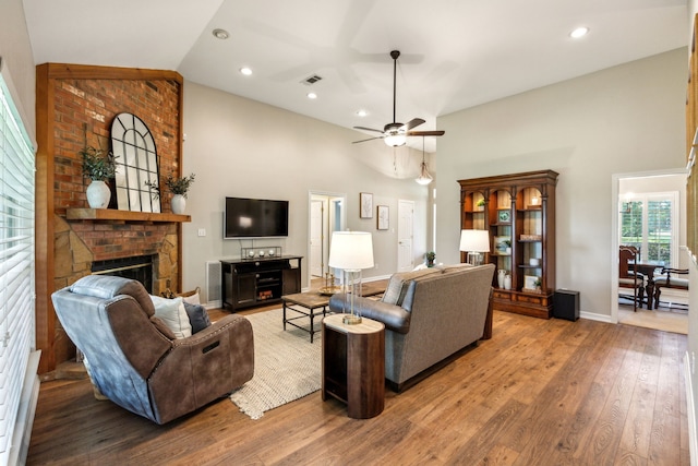 7968 Fm 121, Van Alstyne, TX 75495 - living area featuring a brick fireplace, high vaulted ceiling, a ceiling fan, wood finished floors, and baseboards
