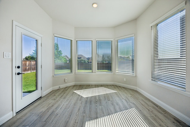 808 N Brenham Ave, Celina, TX 75009 - unfurnished sunroom featuring wood finished floors and baseboards