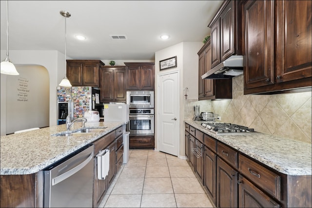 31 Oakridge Ln, Edgecliff Village, TX 76134 - kitchen with stainless steel appliances, under cabinet range hood, a sink, dark brown cabinets, and backsplash