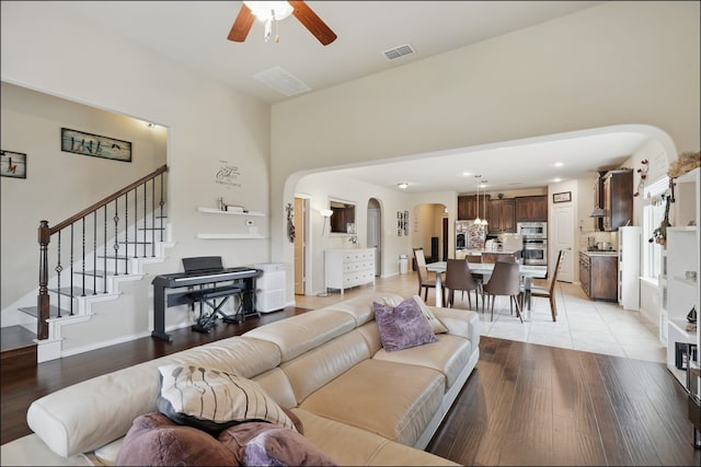 31 Oakridge Ln, Edgecliff Village, TX 76134 - living area featuring arched walkways, a ceiling fan, light wood finished floors, stairs, and recessed lighting