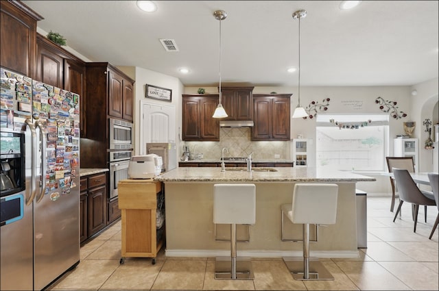 31 Oakridge Ln, Edgecliff Village, TX 76134 - kitchen featuring stainless steel appliances, a sink, tasteful backsplash, light tile patterned flooring, and a kitchen bar
