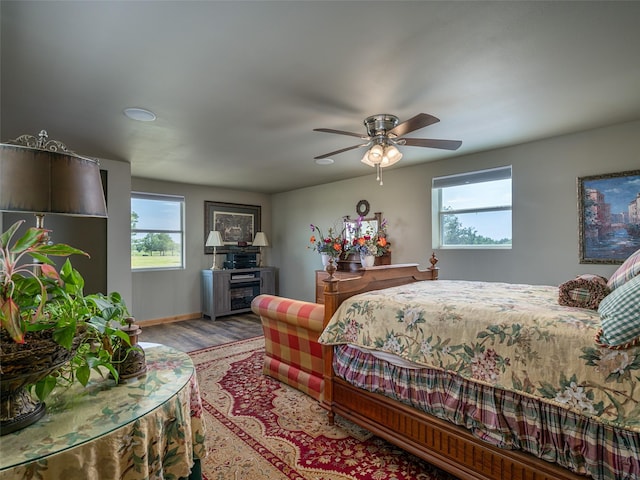 12090 W Fm 346, Bullard, TX 75757 - bedroom featuring multiple windows, wood finished floors, baseboards, and a ceiling fan