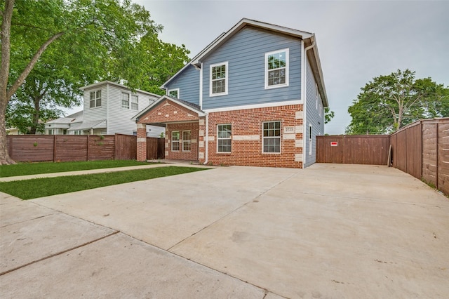 2723 Bentley Ave, Dallas, TX 75211 - back of house featuring concrete driveway, brick siding, and a patio area