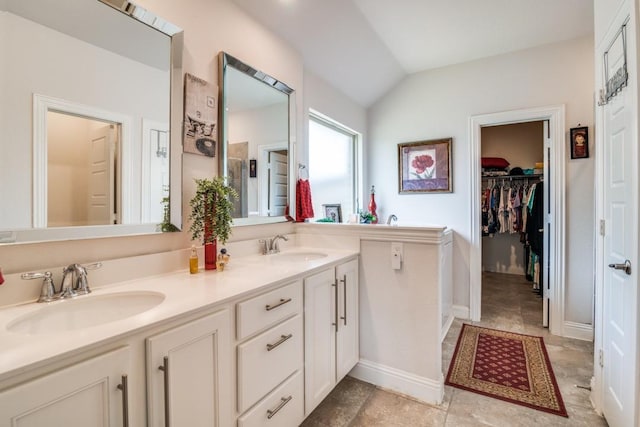 324 Jefferson Ln, Fate, TX 75189 - full bath featuring double vanity, vaulted ceiling, a spacious closet, and baseboards