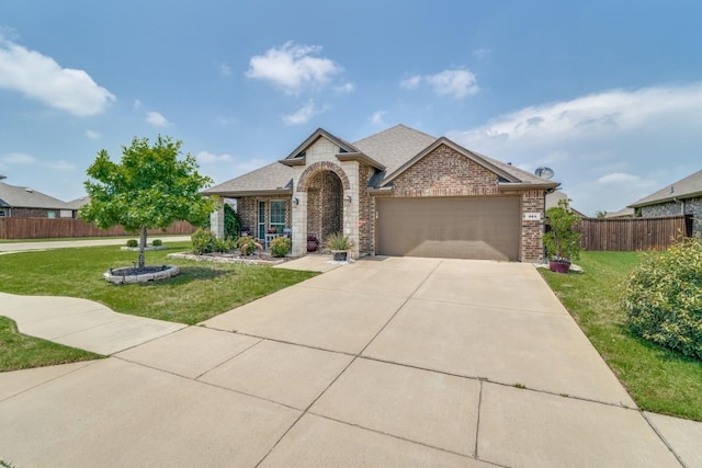 324 Jefferson Ln, Fate, TX 75189 - view of front of property featuring brick siding, an attached garage, concrete driveway, roof with shingles, and stone siding