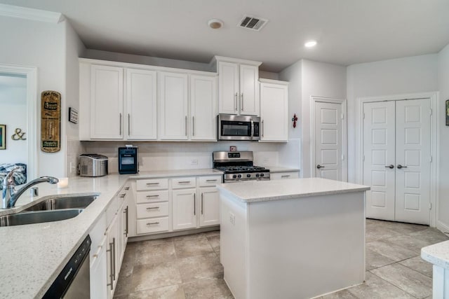 324 Jefferson Ln, Fate, TX 75189 - kitchen with appliances with stainless steel finishes, white cabinetry, recessed lighting, a kitchen island, and tasteful backsplash