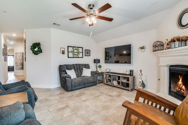 324 Jefferson Ln, Fate, TX 75189 - living room with ceiling fan, a lit fireplace, baseboards, light tile patterned floors, and lofted ceiling