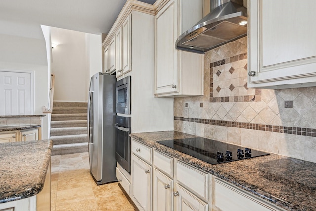 604 Nelson Ct, Plano, TX 75025 - kitchen featuring wall chimney exhaust hood, stainless steel appliances, tasteful backsplash, and cream cabinets