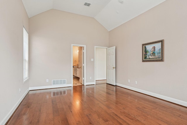 604 Nelson Ct, Plano, TX 75025 - unfurnished bedroom featuring hardwood / wood-style floors, baseboards, ensuite bathroom, and high vaulted ceiling