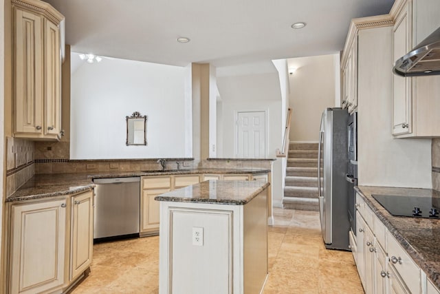 604 Nelson Ct, Plano, TX 75025 - kitchen with appliances with stainless steel finishes, cream cabinetry, a sink, wall chimney range hood, and recessed lighting