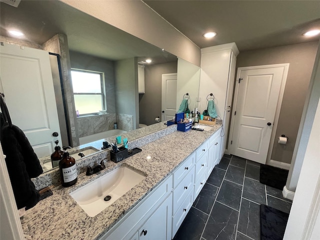 108 Ronnie Ln, Weatherford, TX 76088 - bathroom with double vanity, a bath, recessed lighting, and toilet