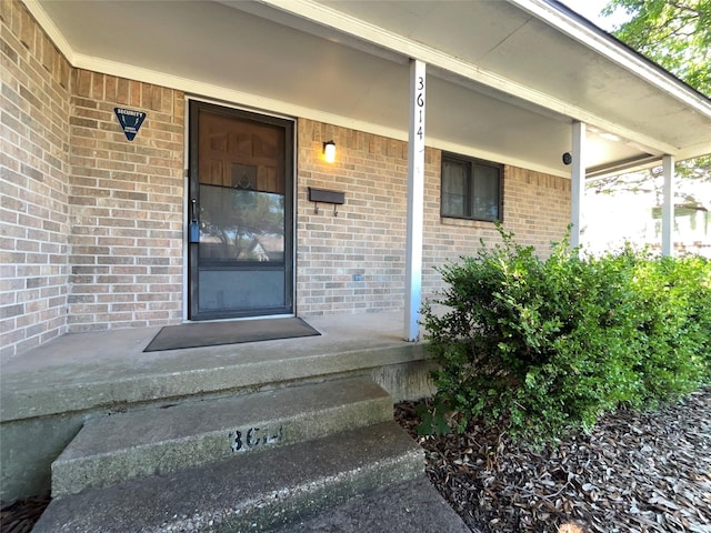3614 Matador Dr, Garland, TX 75042 - view of exterior entry featuring a porch and brick siding