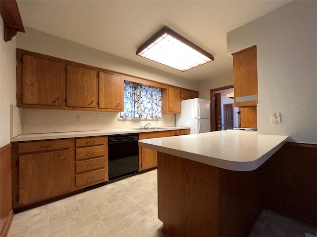 3614 Matador Dr, Garland, TX 75042 - kitchen with dishwasher, freestanding refrigerator, brown cabinetry, a peninsula, and light countertops