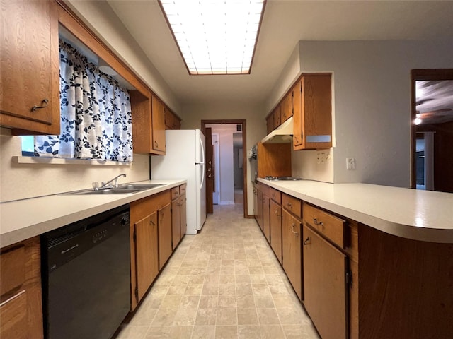 3614 Matador Dr, Garland, TX 75042 - kitchen featuring white appliances, under cabinet range hood, light countertops, brown cabinets, and a sink