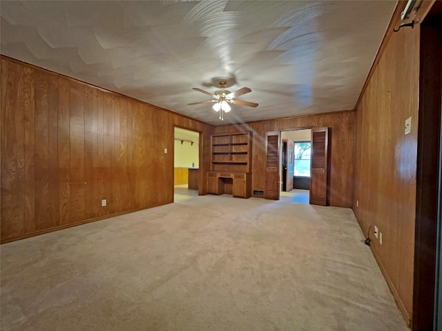 3614 Matador Dr, Garland, TX 75042 - unfurnished room featuring wooden walls, a ceiling fan, and light carpet